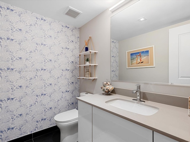 bathroom with tile patterned floors, toilet, and vanity