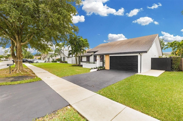 view of front of house with a garage and a front yard