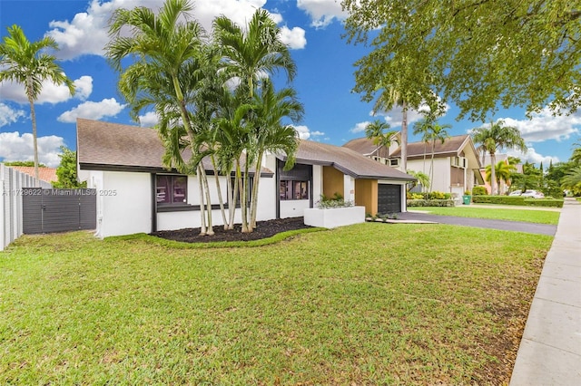 view of front facade with a front yard and a garage