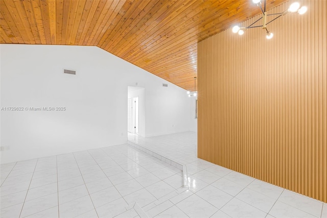 tiled empty room with vaulted ceiling and wooden ceiling