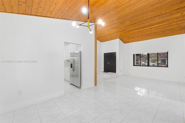 spare room with high vaulted ceiling and wood ceiling