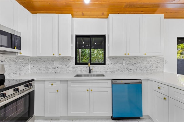 kitchen featuring sink, white cabinets, stainless steel appliances, and tasteful backsplash