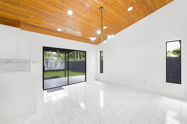 empty room with high vaulted ceiling and wood ceiling