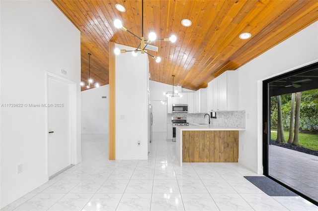 kitchen with white cabinetry, wooden ceiling, appliances with stainless steel finishes, hanging light fixtures, and sink