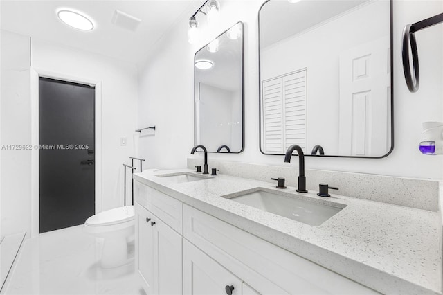 bathroom featuring toilet and vanity