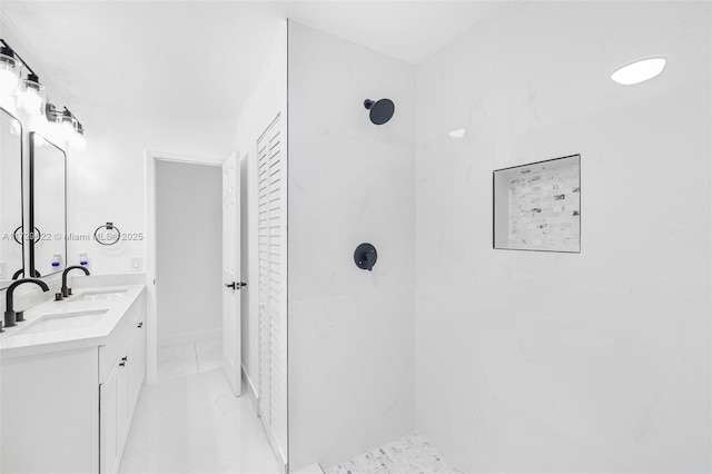 bathroom with vanity and tiled shower