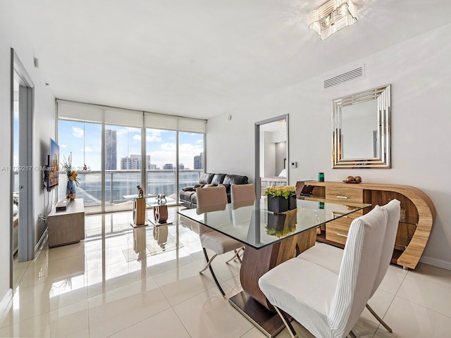 dining area with light tile patterned floors and floor to ceiling windows