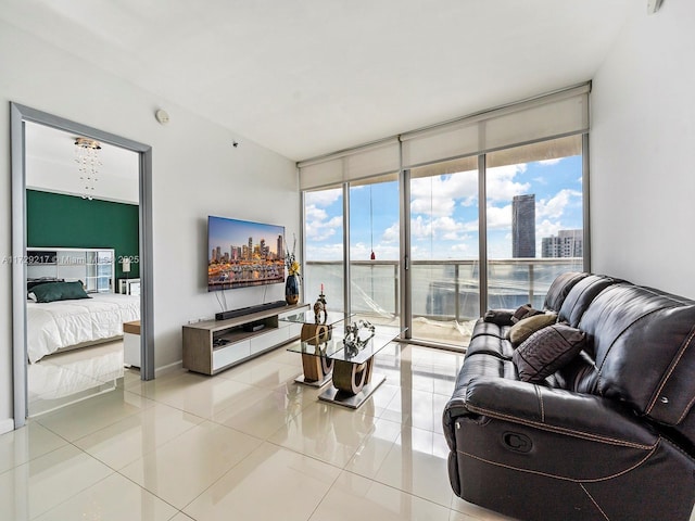 tiled living room featuring a healthy amount of sunlight and expansive windows