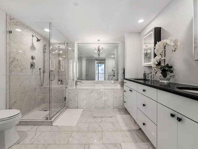 bathroom with vanity, a notable chandelier, and shower with separate bathtub