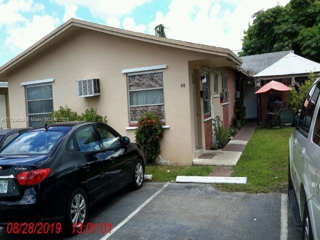 view of side of home featuring uncovered parking and stucco siding