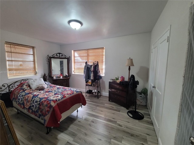 bedroom featuring light wood-type flooring and a closet