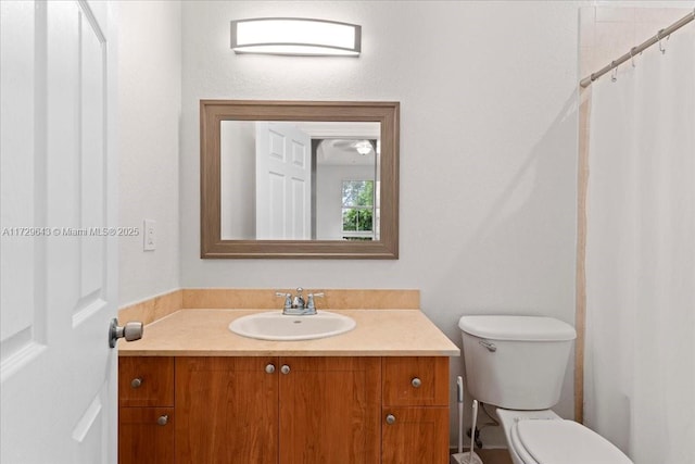 bathroom featuring toilet and vanity