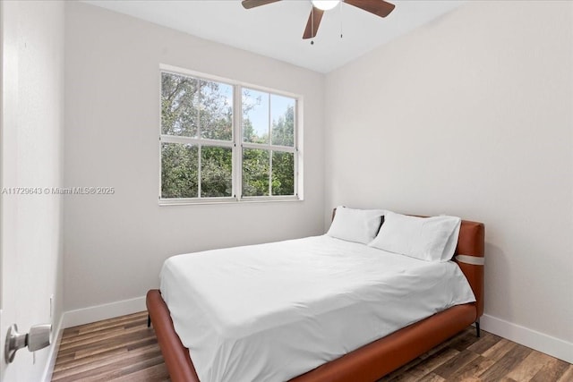 bedroom with ceiling fan and dark hardwood / wood-style floors