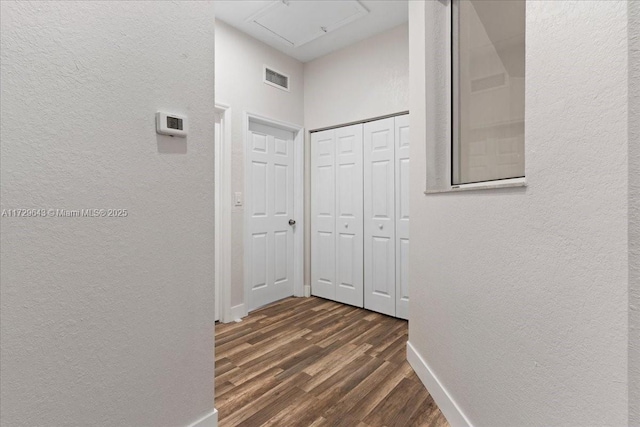 corridor featuring dark hardwood / wood-style flooring