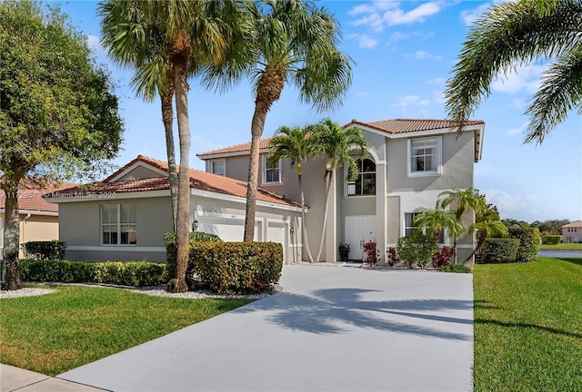 mediterranean / spanish-style home with a garage and a front lawn