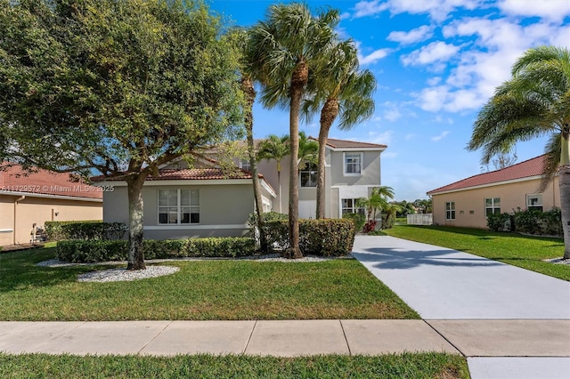 mediterranean / spanish home with a front yard