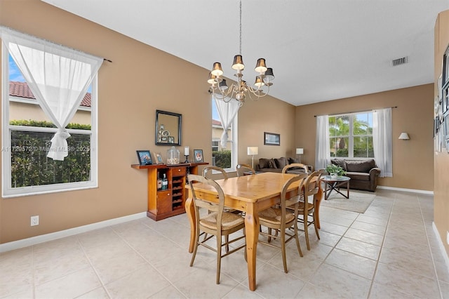 dining space with an inviting chandelier and light tile patterned flooring