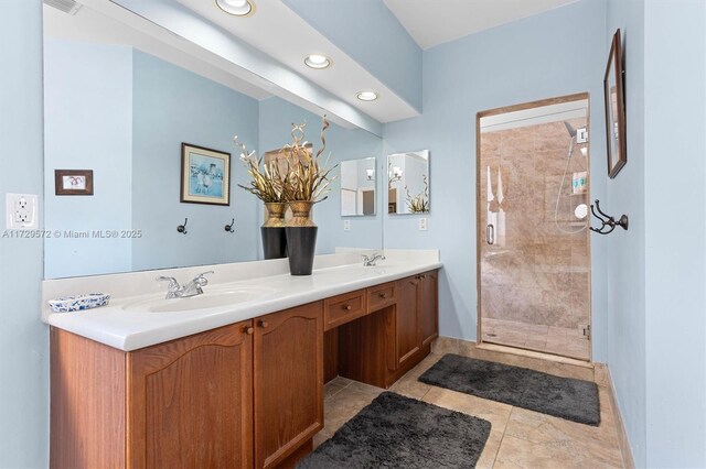 bathroom featuring tile patterned floors, an enclosed shower, and vanity