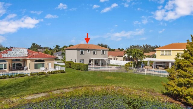 rear view of property with a yard