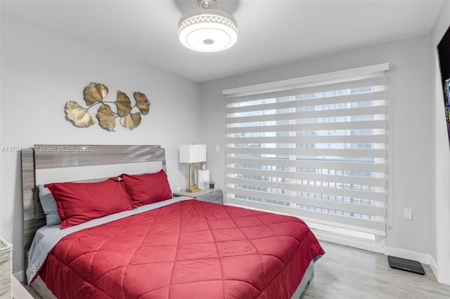 bedroom with hardwood / wood-style flooring