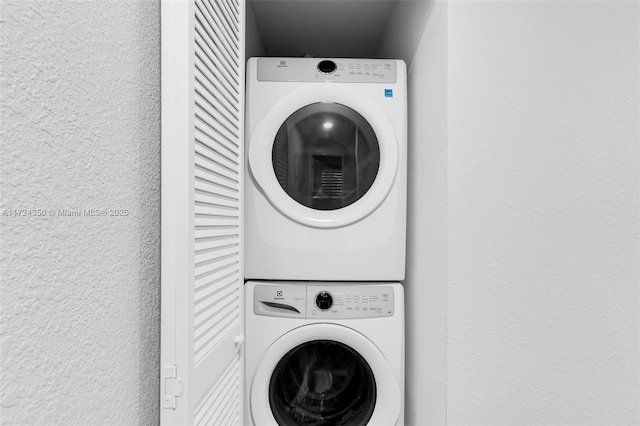 laundry area with stacked washer and clothes dryer