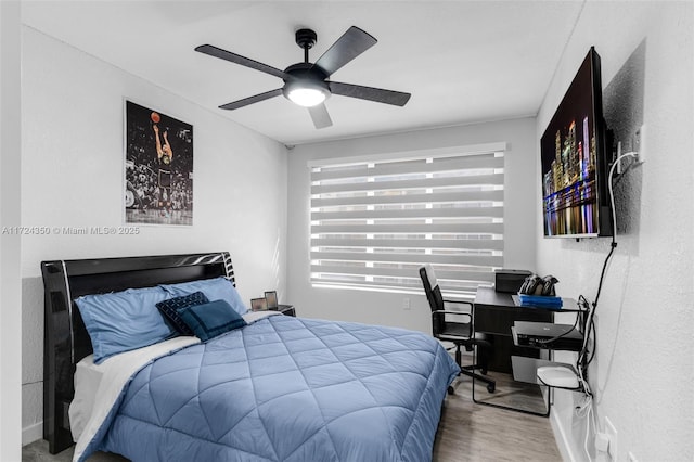 bedroom featuring ceiling fan and wood-type flooring