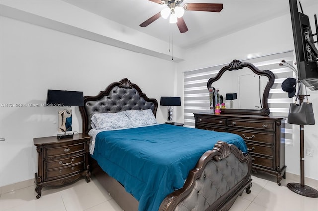 tiled bedroom featuring ceiling fan