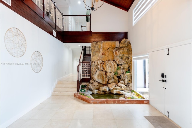 entryway featuring a towering ceiling and a wealth of natural light