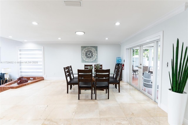 dining area with crown molding and french doors