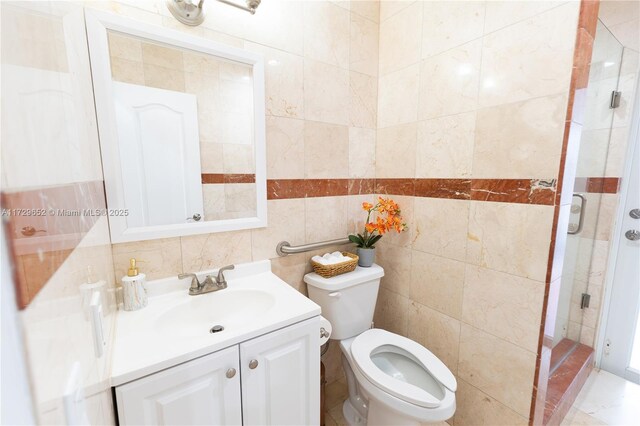 bathroom with vanity, toilet, and tile walls