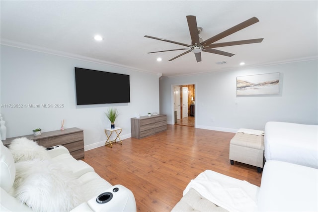 living room featuring crown molding, ceiling fan, and hardwood / wood-style flooring