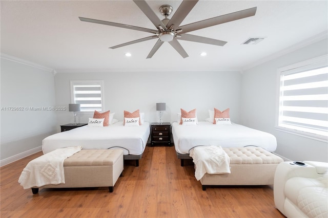 bedroom featuring crown molding, ceiling fan, and light hardwood / wood-style flooring