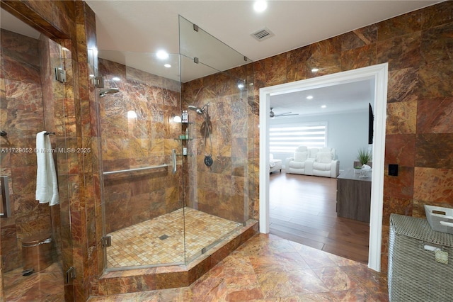 bathroom with tile walls and a shower with shower door