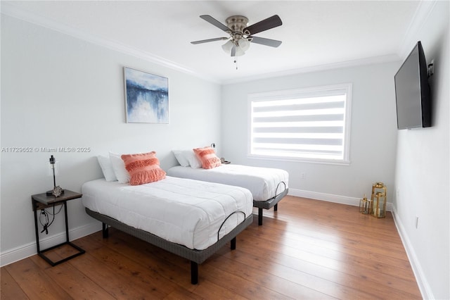 bedroom featuring wood-type flooring, ornamental molding, and ceiling fan