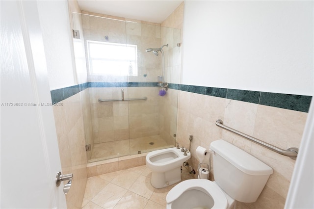 bathroom with a bidet, tile patterned flooring, tile walls, toilet, and walk in shower