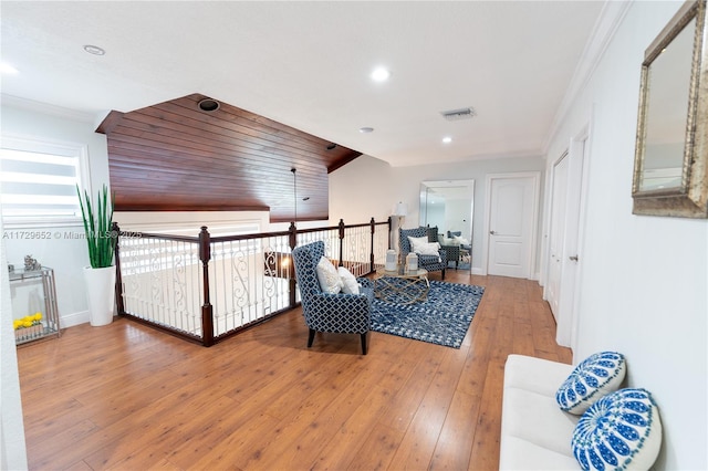 interior space with hardwood / wood-style floors and crown molding