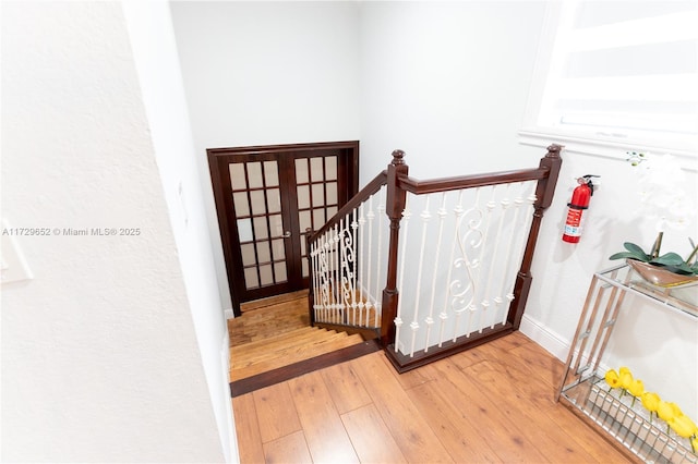 staircase with hardwood / wood-style floors