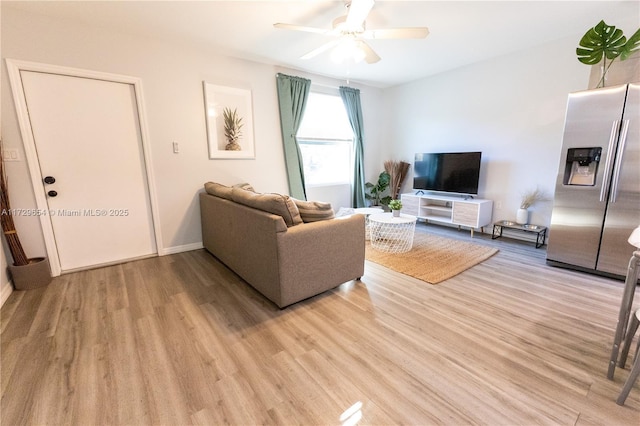 living room with ceiling fan and light wood-type flooring