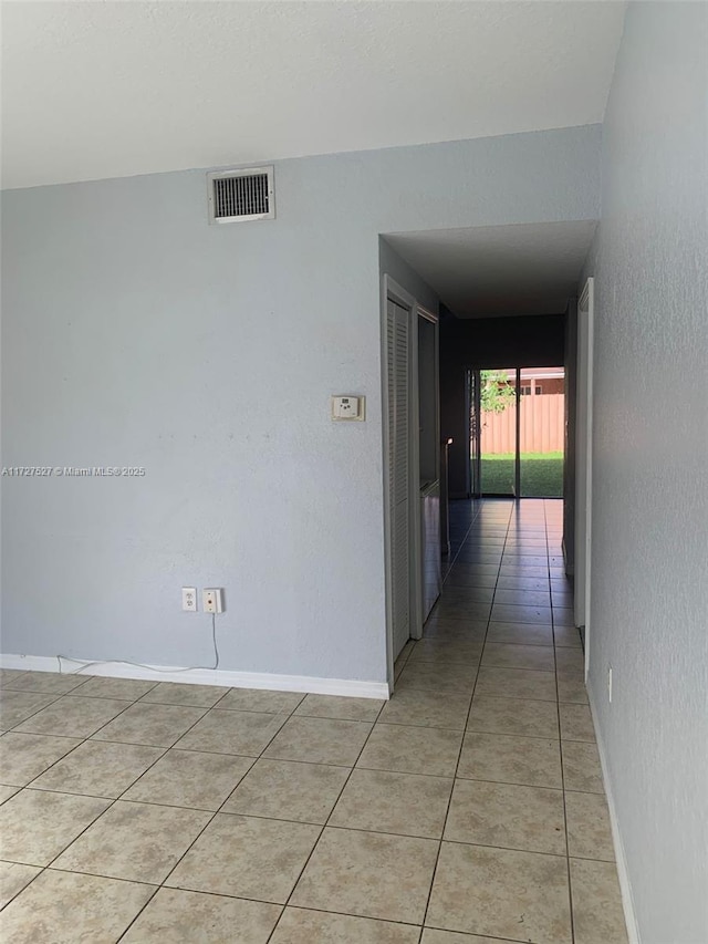 hall featuring light tile patterned floors