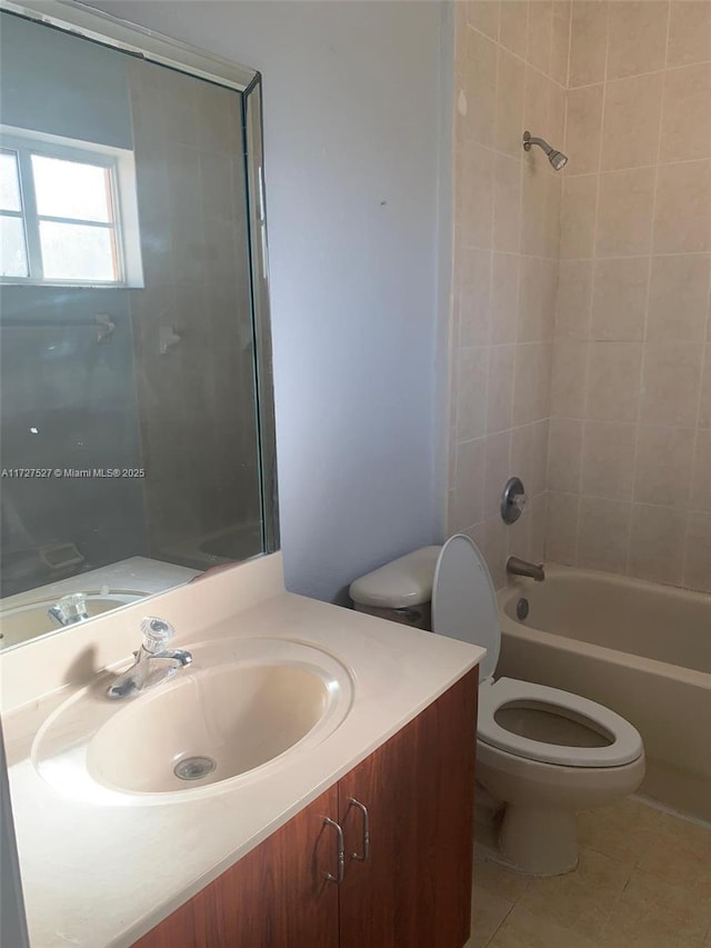 full bathroom with toilet, tiled shower / bath combo, tile patterned floors, and vanity