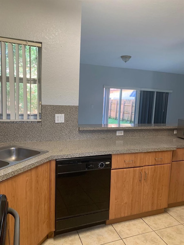 kitchen with tasteful backsplash, light tile patterned flooring, dishwasher, range, and sink