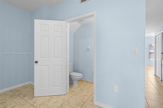 bathroom featuring toilet and tile patterned floors