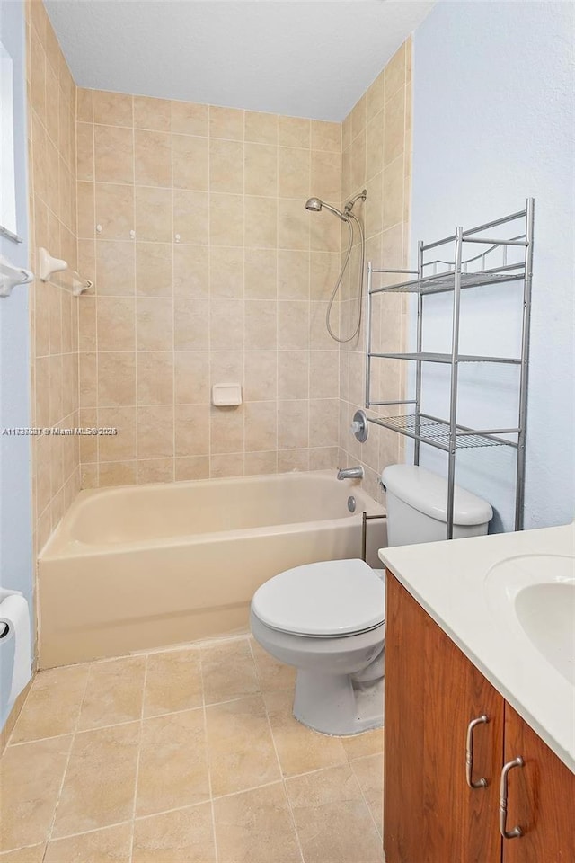 full bathroom featuring tile patterned floors, toilet, vanity, and tiled shower / bath combo