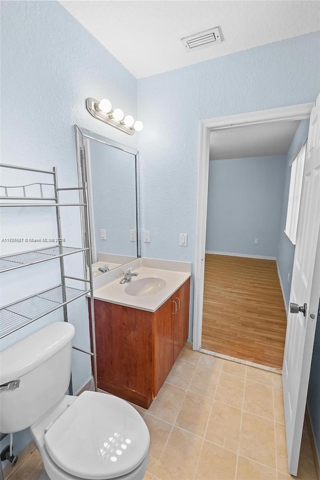 bathroom with tile patterned floors, toilet, and vanity