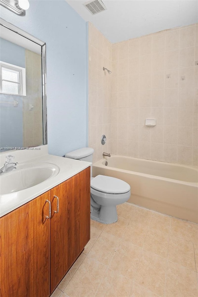 full bathroom with toilet, tiled shower / bath combo, and vanity