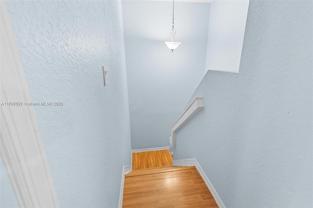 stairs featuring hardwood / wood-style flooring