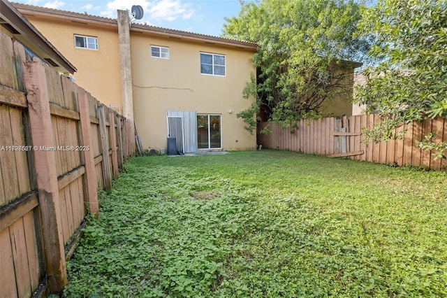 rear view of house with a yard