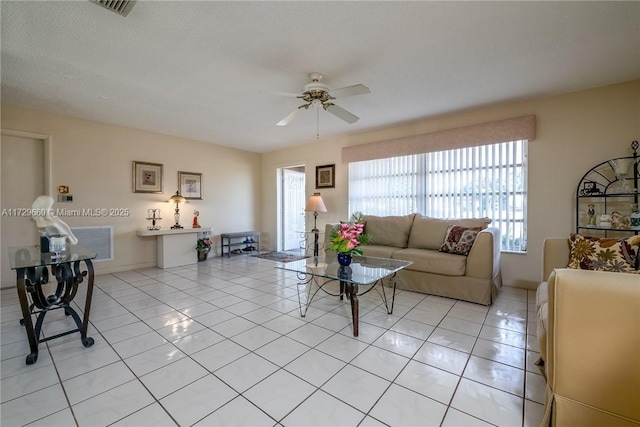 tiled living room with ceiling fan