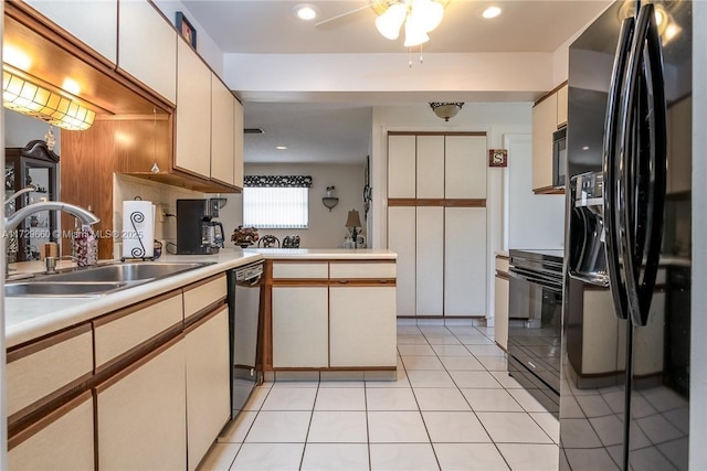 kitchen with sink, light tile patterned floors, kitchen peninsula, ceiling fan, and black appliances