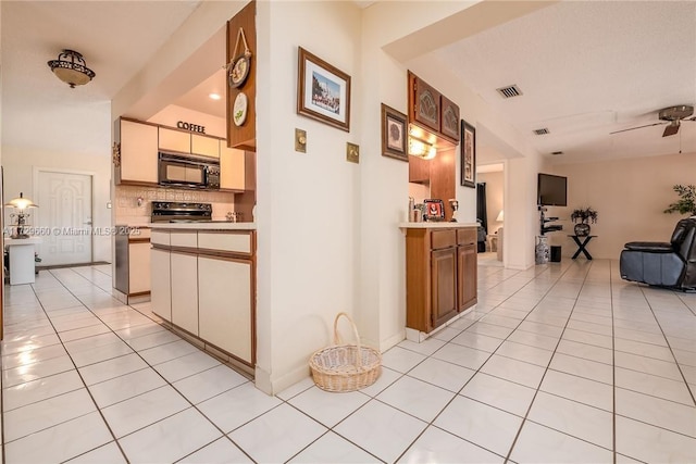 hall featuring light tile patterned floors